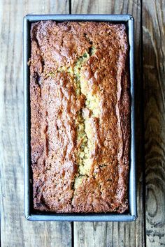 a loaf of zucchini bread sitting on top of a wooden table