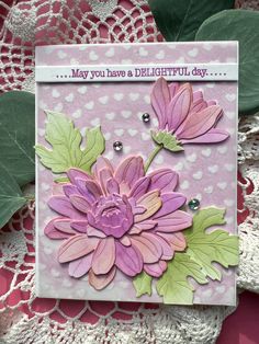 a card with pink flowers and green leaves