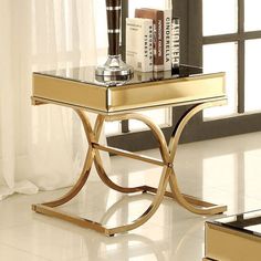 a table with some books on it and a vase sitting on top of the table