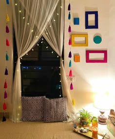 a living room filled with lots of furniture next to a window covered in white curtains