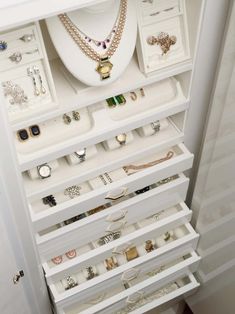 a white cabinet filled with lots of jewelry