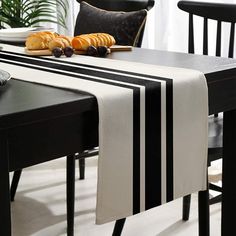 a black and white striped table runner on a dining room table