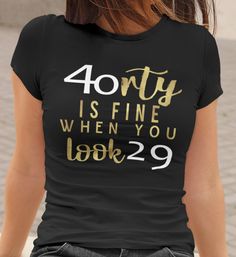 a woman wearing a black shirt that says forty is fine when you look 29