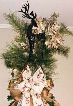 a christmas wreath with deer and pine cones