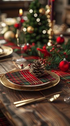 a christmas table setting with pine cone centerpiece and plaid napkins on the placemat