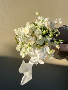 a bouquet of white flowers sitting on top of a table