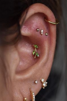 a woman wearing three different ear piercings