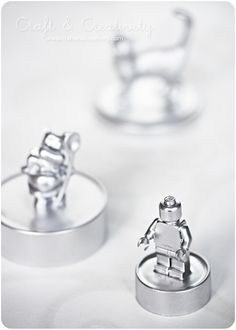 two silver rings with small figures on them