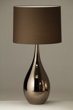 the lamp is shiny and has a brown shade on it's base, which matches the color of the lampshade