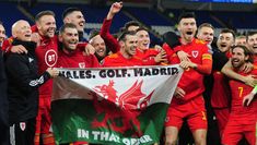 the wales team celebrates with their trophy