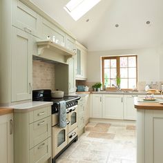 a kitchen with an oven, stove and sink