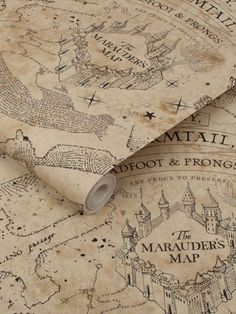 an old map is laying on top of a tablecloth that has been drawn onto it