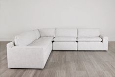 a white couch sitting on top of a hard wood floor