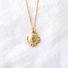 This small but mighty pendant is round with small granulation details on the top, bottom and sides, and bezel set with a teal Montana Sapphire. Product details: Pendant only or on 18" chain Materials: 18k gold pendant, chain is 14K Measurements: .5 inch x .5 inch Sapphire Necklace Pendants, Small But Mighty, Montana Sapphire, Sapphire Pendant, Sapphire Necklace, Jewelry Inspo, Bling Bling, Bezel Setting, Jewelry Care