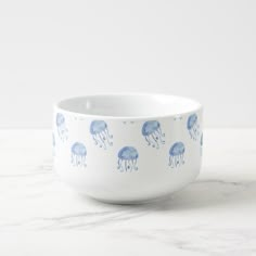 a white bowl with blue jellyfish on it