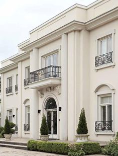 a large white building with many windows and balconies