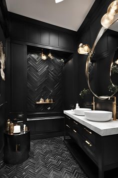 a black and white bathroom with gold accents