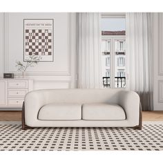 a white couch sitting on top of a black and white checkered floor next to a window