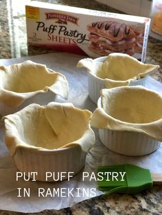 four pie pans sitting on top of a counter with the words put puff pastry in ramekins