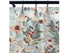 a curtain with flowers on it hanging in front of a white wall and black metal rod