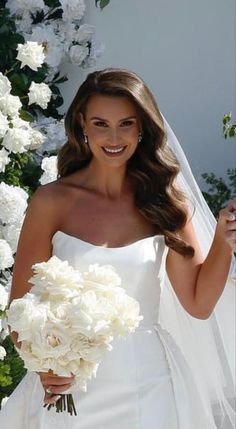 a woman in a wedding dress holding a bouquet