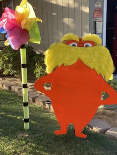 the sesame street character is standing next to a paper pinata tree with a flower in it