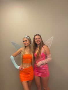 two girls dressed in costumes posing for the camera