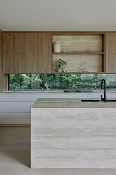 a modern kitchen with wooden cabinets and white counter tops, along with an island in the middle