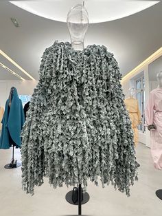 a dress made out of money sitting on top of a table