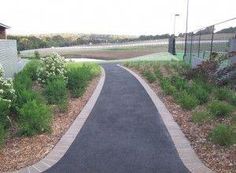 a paved road in the middle of a grassy area