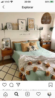 a bed room with a neatly made bed and lots of pictures on the wall above it