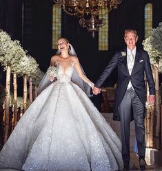 a bride and groom walking down the aisle