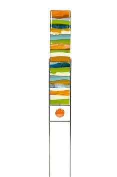 a tall metal rack with an orange and green striped piece on it's side