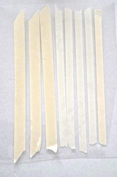 several strips of white paper laid on top of each other