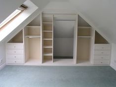 an attic bedroom with built - in shelving and closets