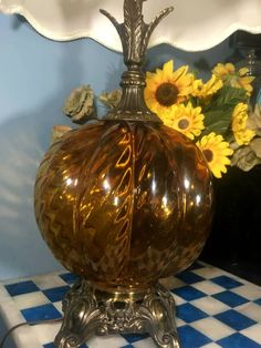 a vase sitting on top of a blue and white checkered table