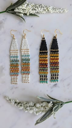 three beaded earrings on a marble surface