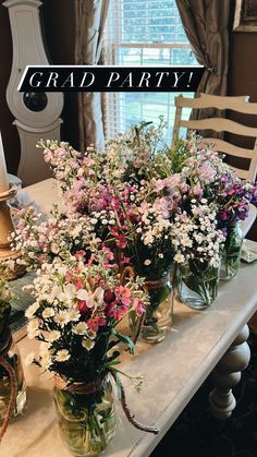 a table topped with vases filled with flowers