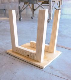 two pieces of wood sitting on top of a wooden stand in the middle of a room