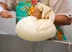 a man is holding a large white object in one hand and pulling it out of the other