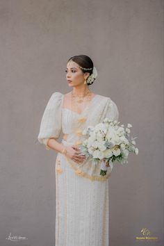 a woman in a white dress holding a bouquet