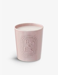 a pink candle with the words roses on it