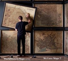 a man standing in front of a wall with maps on it and the words world historic maps