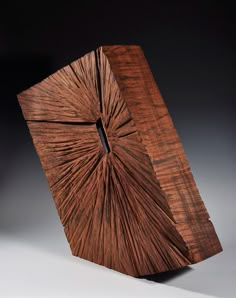 a piece of wood that has been carved into the shape of a square, with an intricate