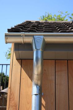 a metal gutter attached to the side of a house