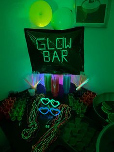 glow bar with neon glasses and party supplies