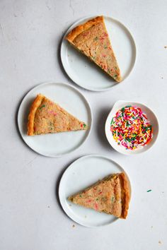 three slices of pie on plates with sprinkles