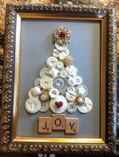 a christmas tree made out of buttons in a frame