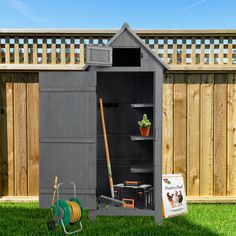 an outdoor storage shed with tools and gardening equipment in the back yard next to a fence