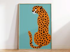 an orange and black cheetah sitting on top of a wooden floor next to a blue wall